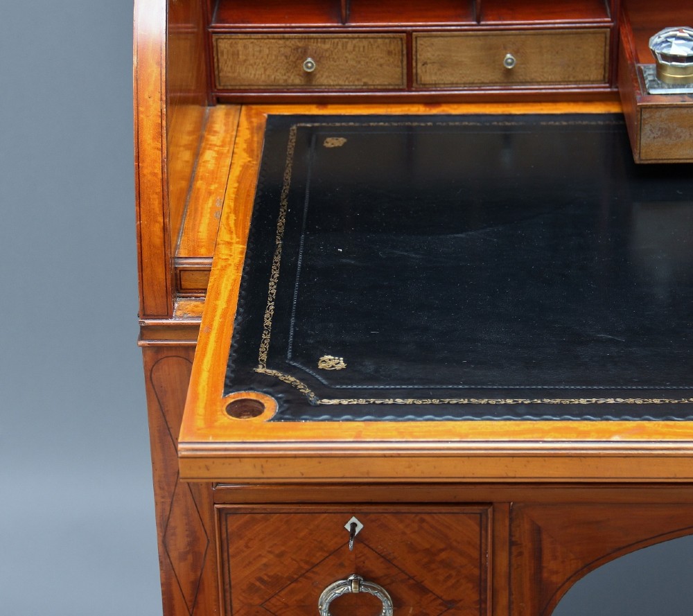 A 19th-century satinwood cylinder bureau bookcase featuring upper glazed doors, a roll-top writing section, lower drawers, and turned fluted legs. View XI