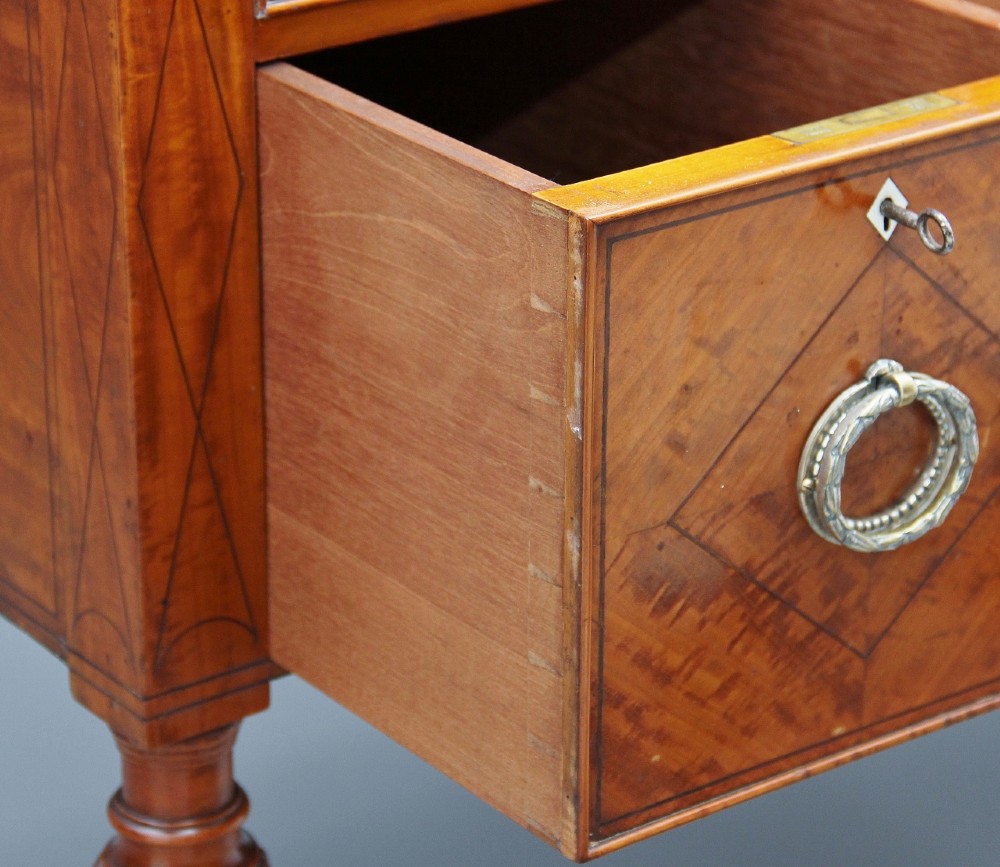 A 19th-century satinwood cylinder bureau bookcase featuring upper glazed doors, a roll-top writing section, lower drawers, and turned fluted legs. View XV