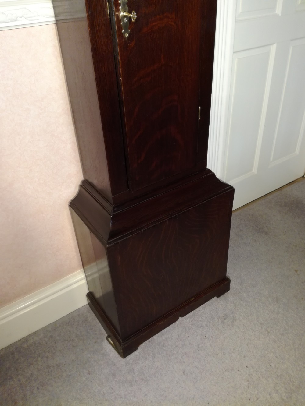 A Georgian dark mahogany longcase clock featuring an arched dial hood with turned columns and a tall waist door. View VII