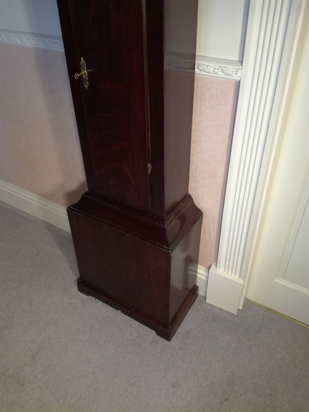 A Georgian dark mahogany longcase clock featuring an arched dial hood with turned columns and a tall waist door. View VIII