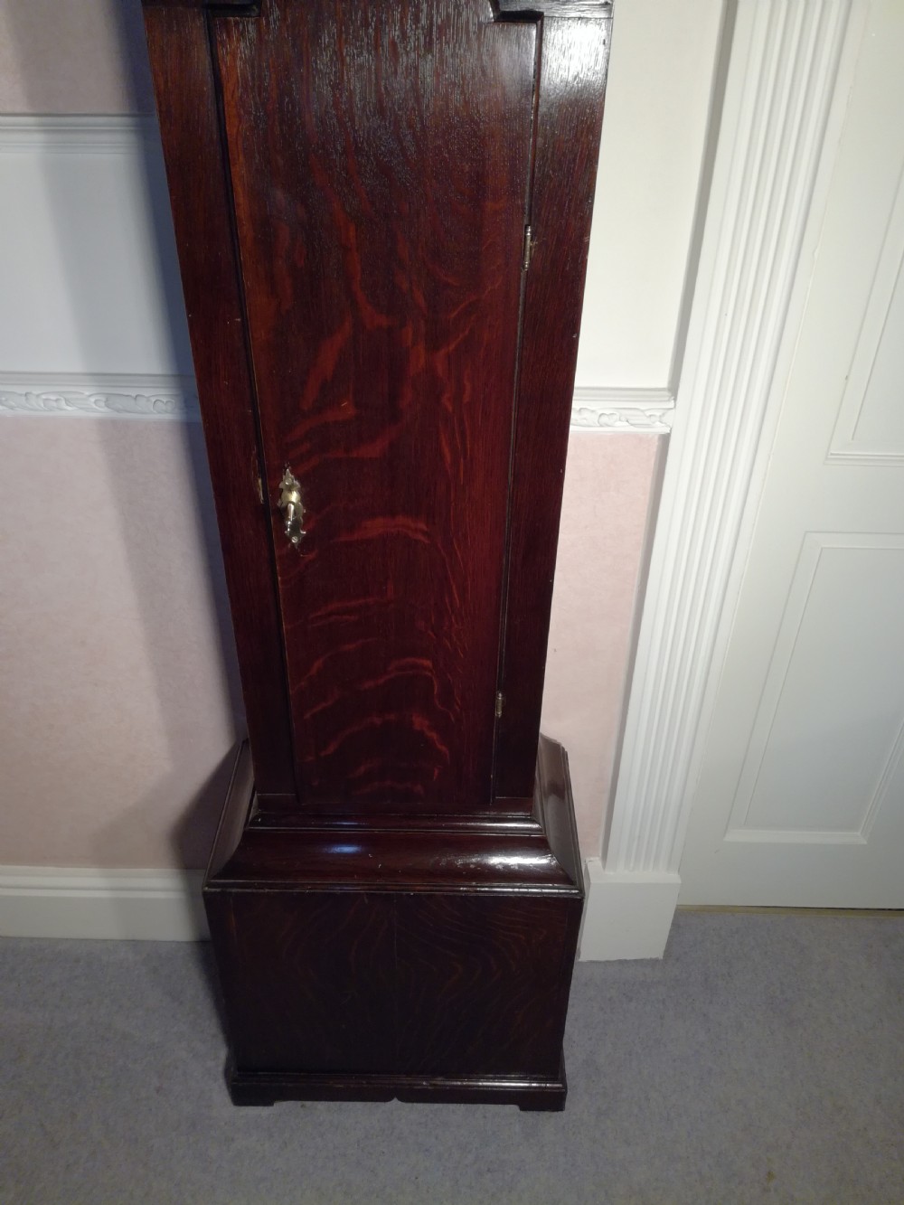 A Georgian dark mahogany longcase clock featuring an arched dial hood with turned columns and a tall waist door. View IX