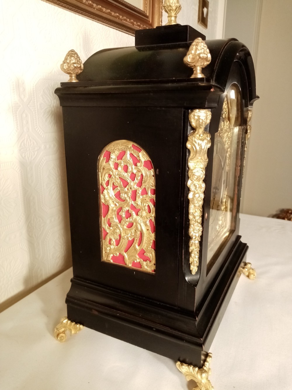A Victorian ebonised bracket clock featuring gilt brass caryatid mounts, pinecone finials, scroll feet, and a brass dial with silvered chapter ring. View III