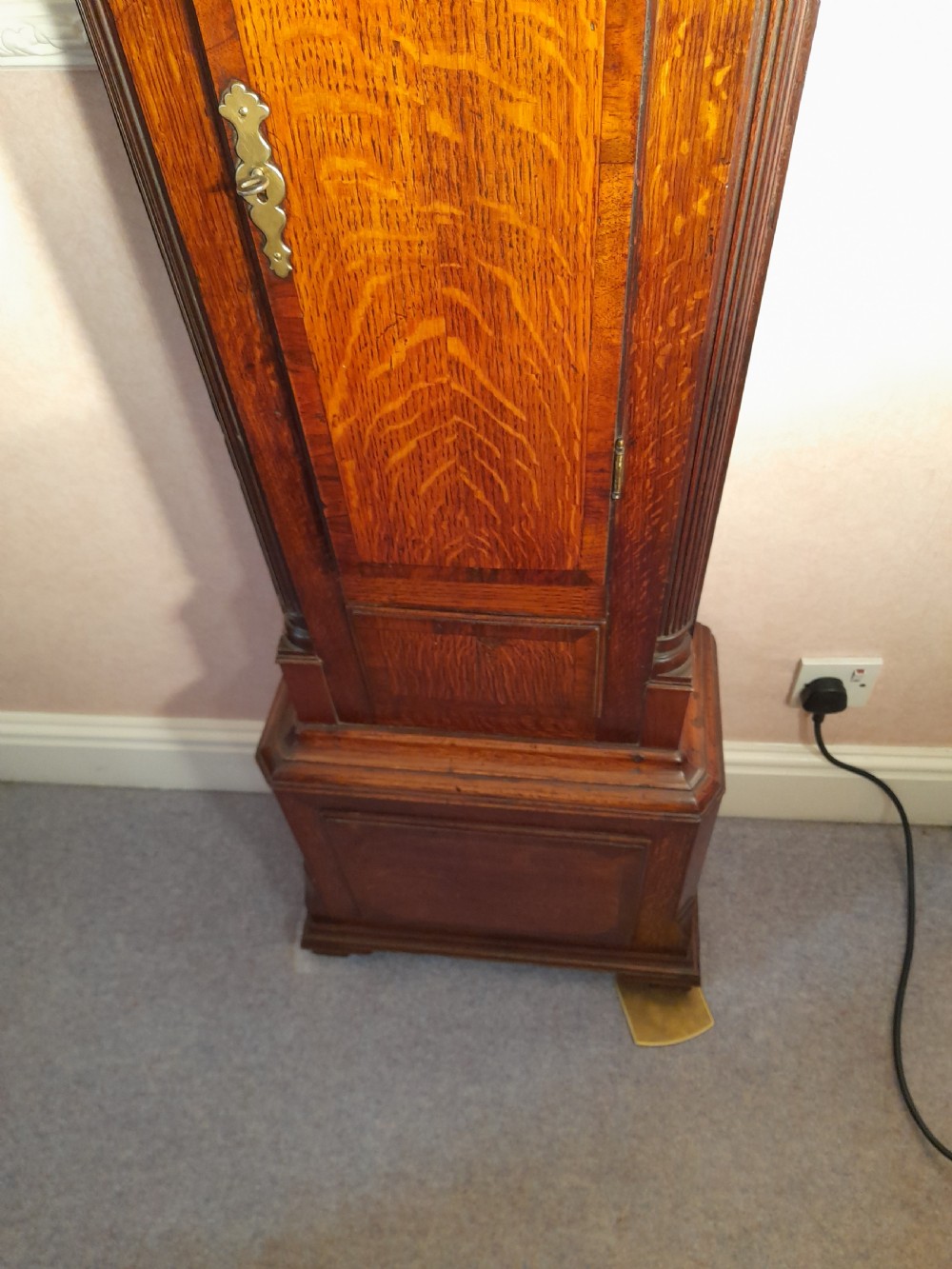 A Georgian mahogany longcase clock featuring a swan-neck pediment with a brass eagle finial and an engraved brass dial. View VII