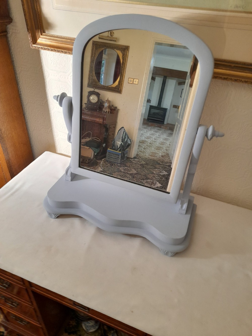 A grey-painted Victorian swing dressing table mirror featuring an arched glass frame set between turned supports on a contoured serpentine base. View V