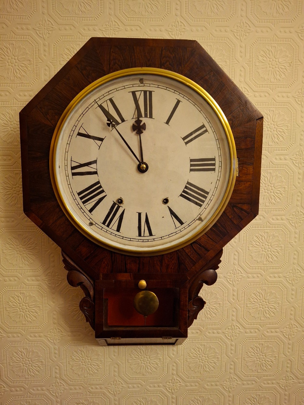 Victorian octagonal drop-dial wall clock crafted from dark rosewood with a brass-bezel white dial and Roman numerals. View II