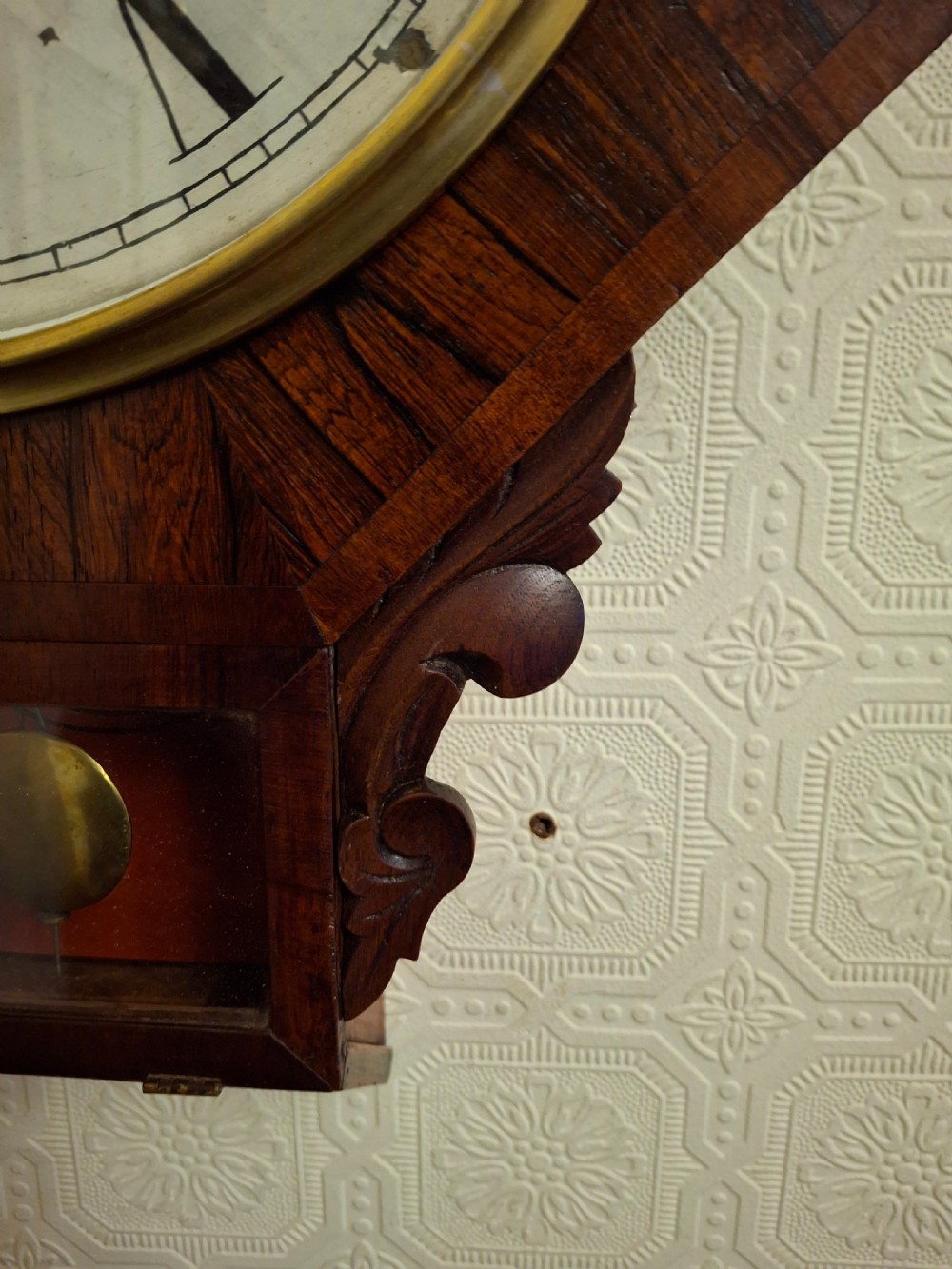 Victorian octagonal drop-dial wall clock crafted from dark rosewood with a brass-bezel white dial and Roman numerals. View IV