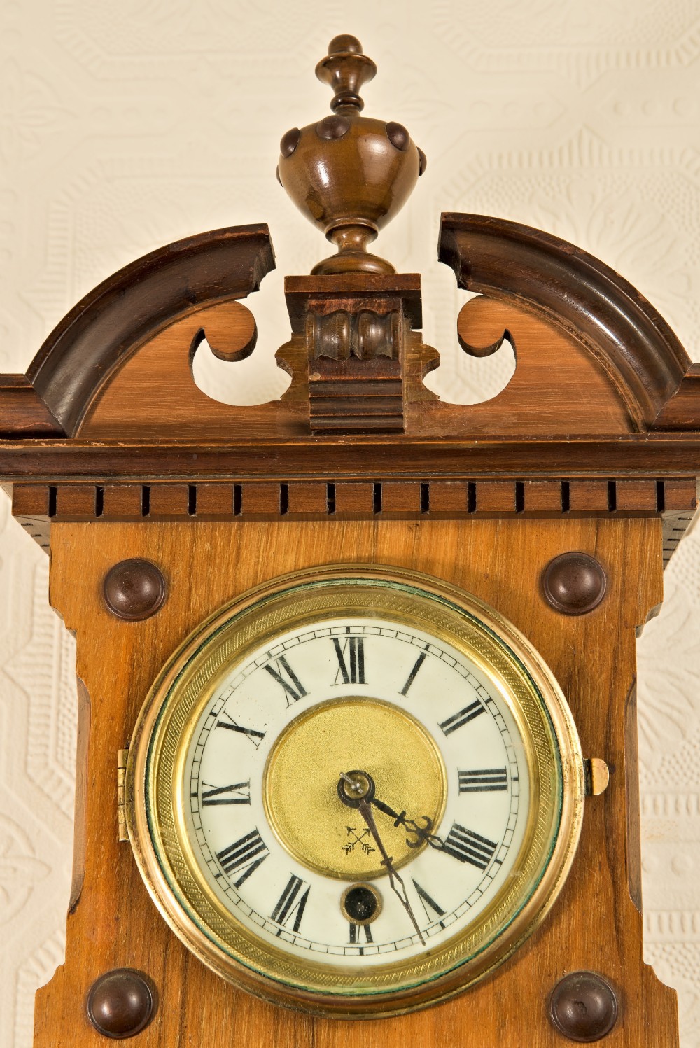 A wall-hung antique walnut clock, thermometer, and aneroid barometer companion set featuring carved pediment ornamentation and brass-rimmed dials. View II