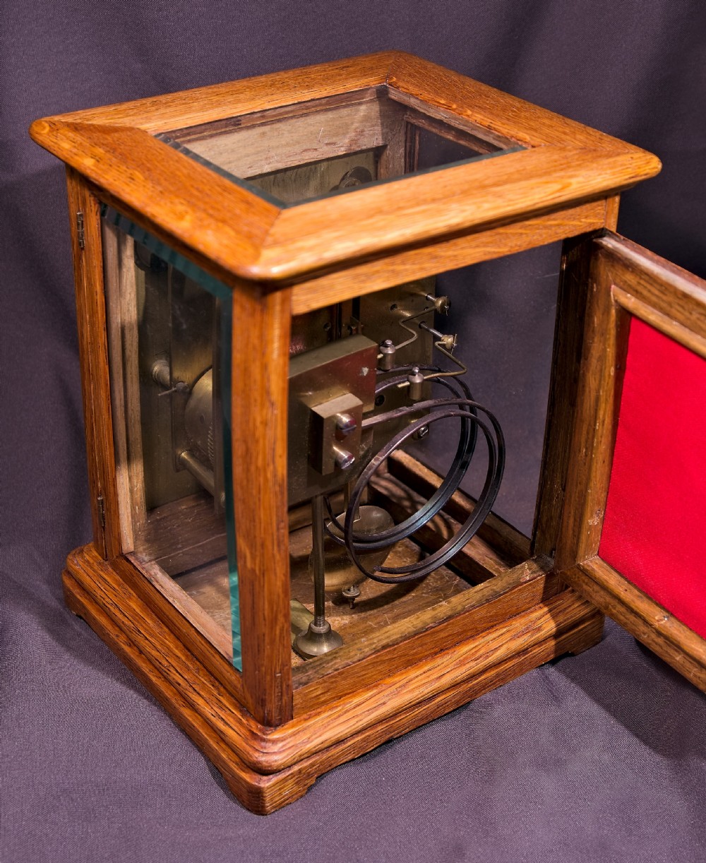 An antique golden oak four-glass bracket clock featuring a silvered brass dial with subsidiary chime controls. View II