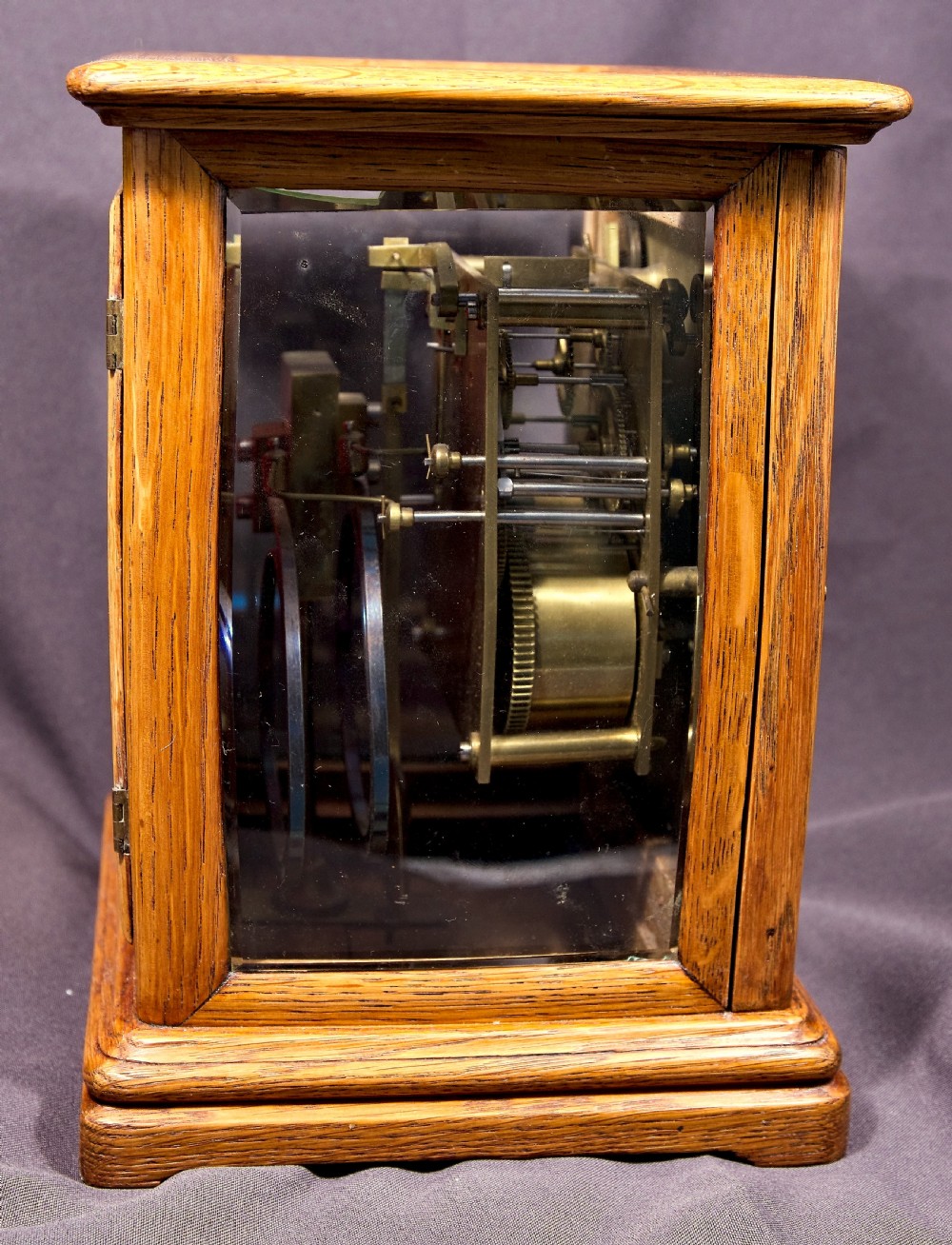 An antique golden oak four-glass bracket clock featuring a silvered brass dial with subsidiary chime controls. View V