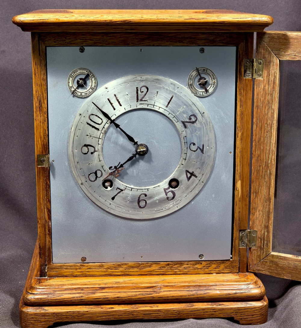 An antique golden oak four-glass bracket clock featuring a silvered brass dial with subsidiary chime controls. View VII