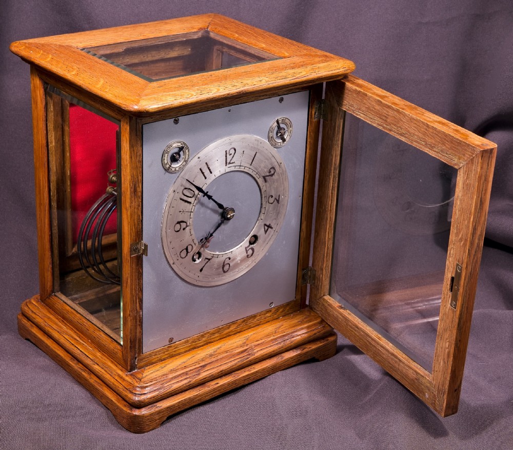 An antique golden oak four-glass bracket clock featuring a silvered brass dial with subsidiary chime controls. View VIII