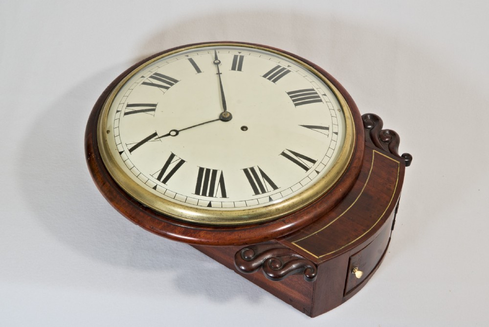 A Victorian mahogany fusee wall clock featuring a cream painted dial with Roman numerals, a brass bezel, and carved side scroll ears. View II