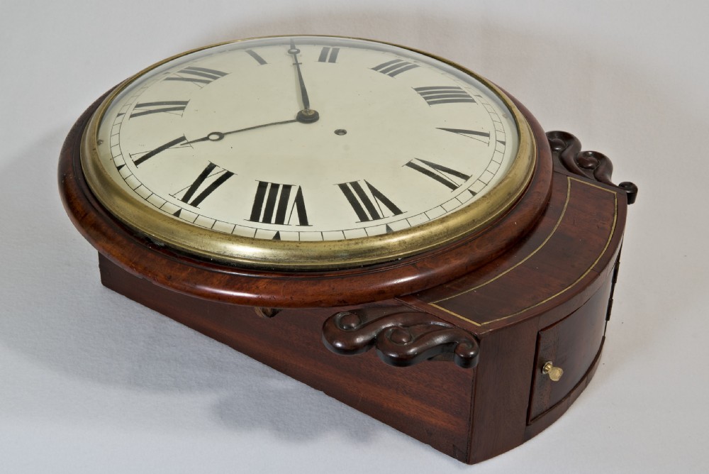 A Victorian mahogany fusee wall clock featuring a cream painted dial with Roman numerals, a brass bezel, and carved side scroll ears. View III