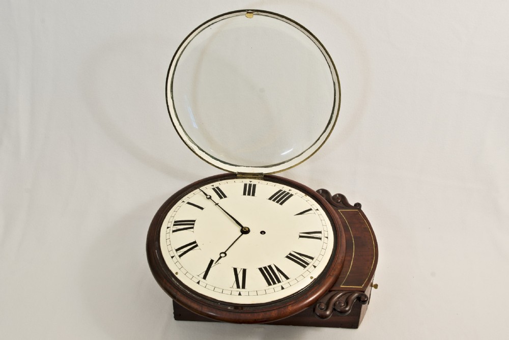 A Victorian mahogany fusee wall clock featuring a cream painted dial with Roman numerals, a brass bezel, and carved side scroll ears. View VI