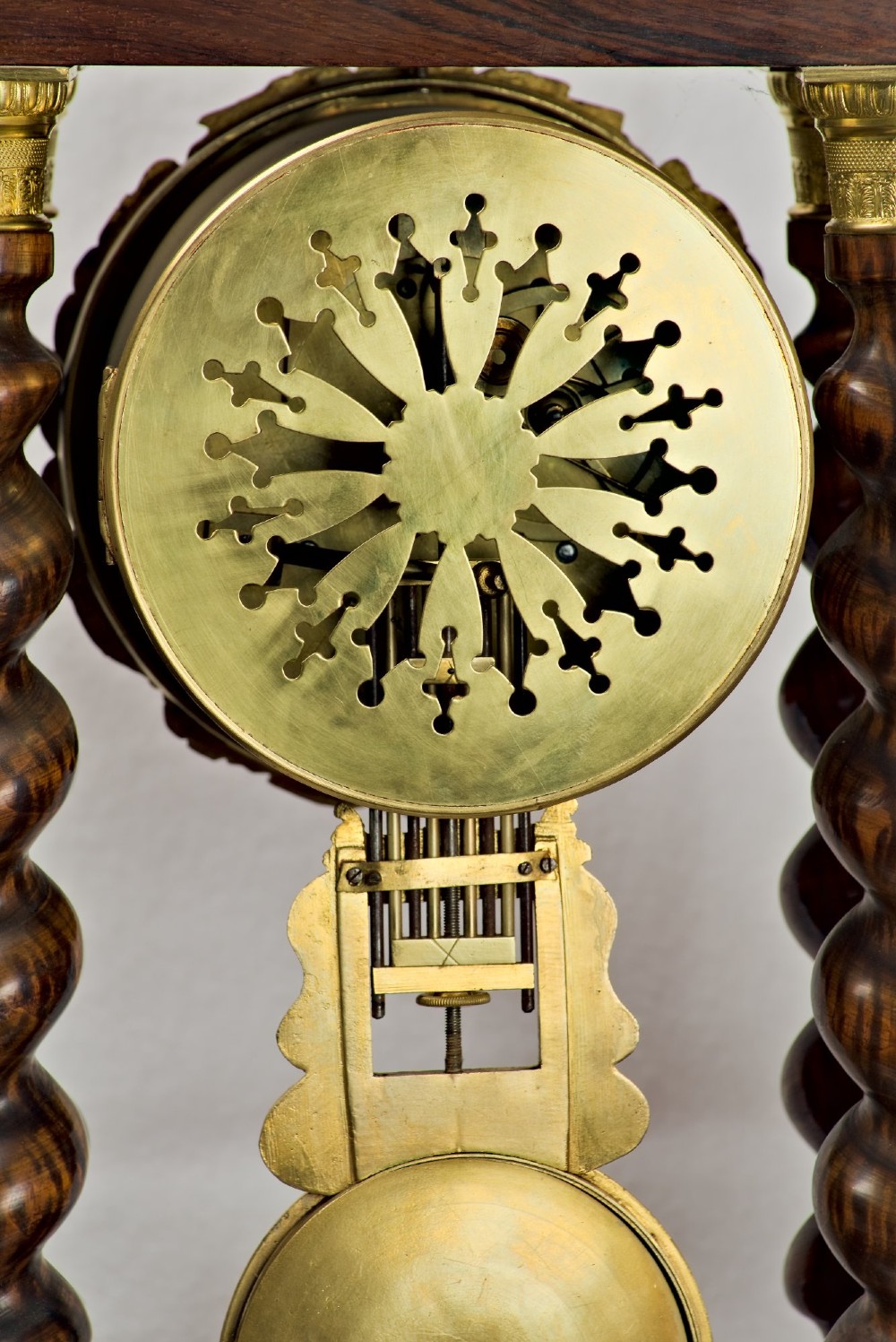 A 19th-century rosewood portico clock featuring floral marquetry inlays, twin barley-twist columns with gilt capitals, and a white enamel dial with an ornate gilt bezel. View IX