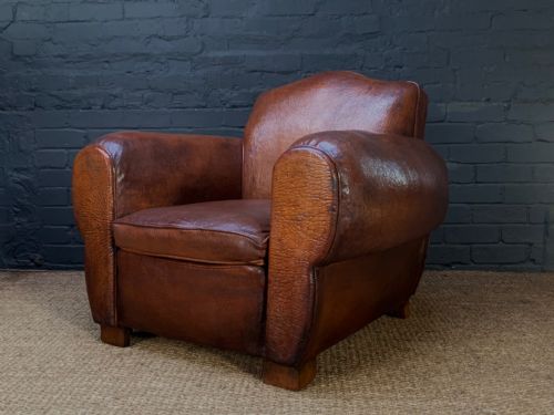 An Impressive French Leather Club Chair, Chapeau du Gendarme Model, Circa 1920's, Le Giant Model, with over-stuffed cigar arms