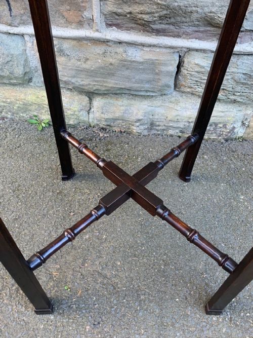 fig 1. An antique dark mahogany lamp table featuring a gallery tray top, pierced fretwork apron, corner brackets, and turned cross-stretchers.