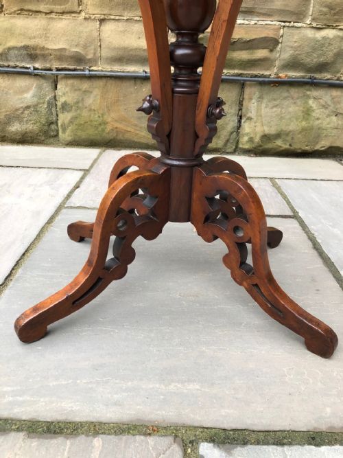 fig 1. An antique Victorian oval walnut games table featuring an inlaid chessboard top and carved tripod pedestal base.