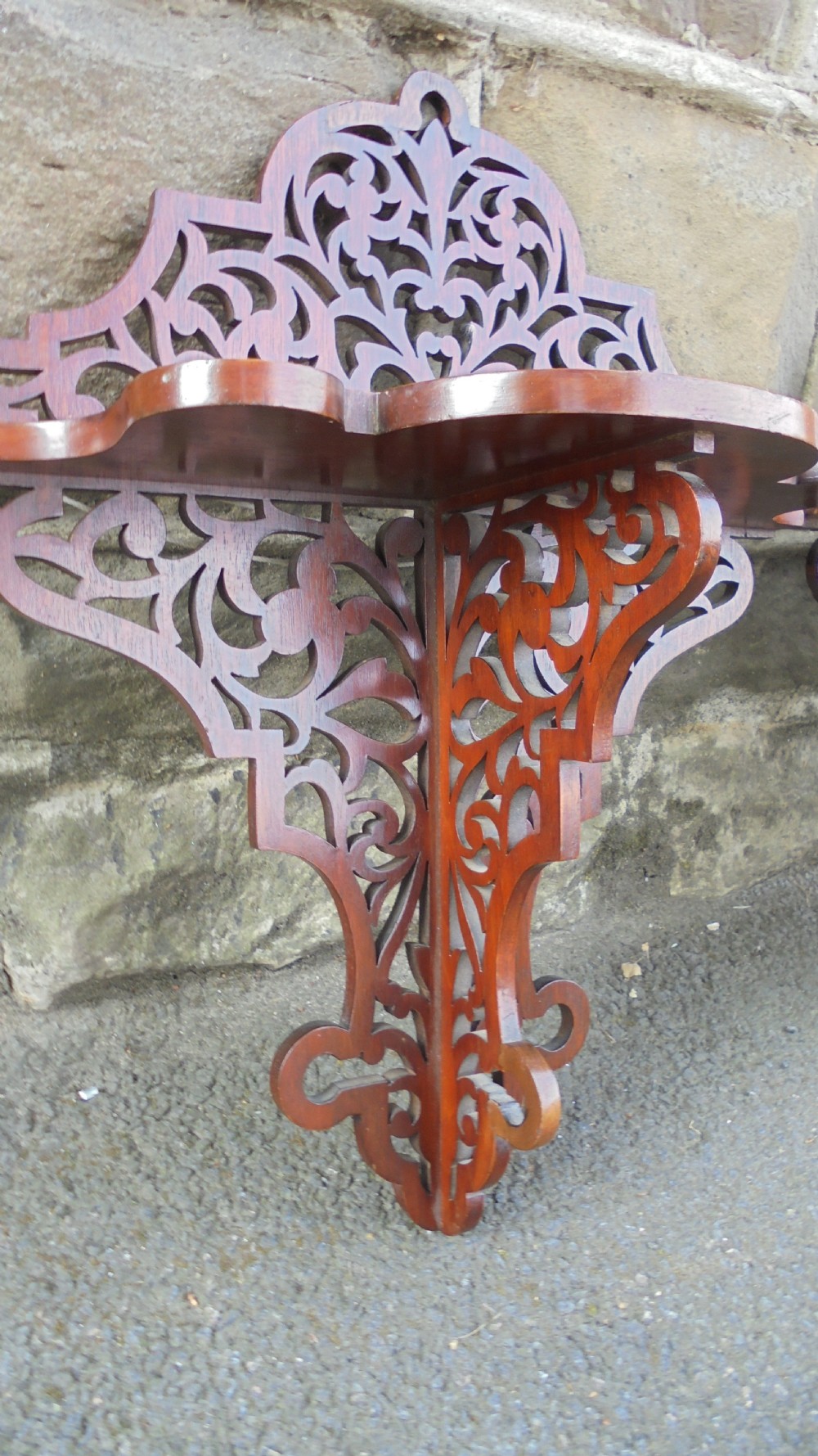 A pair of carved walnut wall brackets featuring pierced fretwork scroll designs and flat top display surfaces. View III