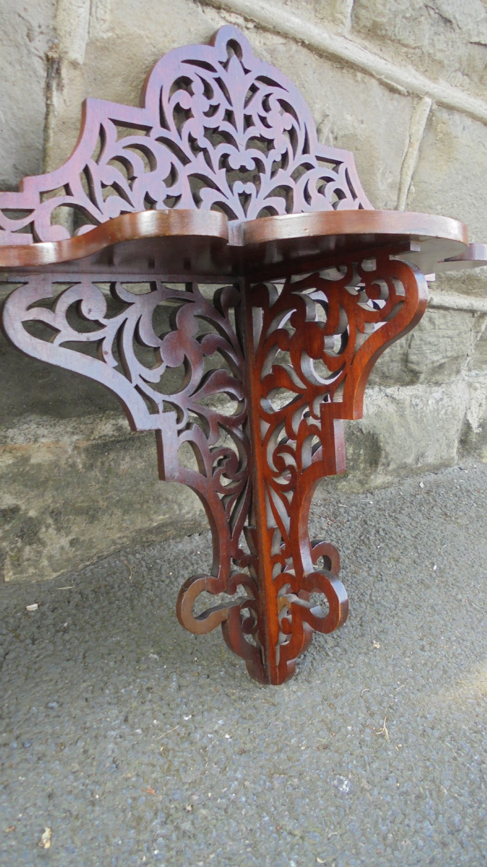 A pair of carved walnut wall brackets featuring pierced fretwork scroll designs and flat top display surfaces. View IV