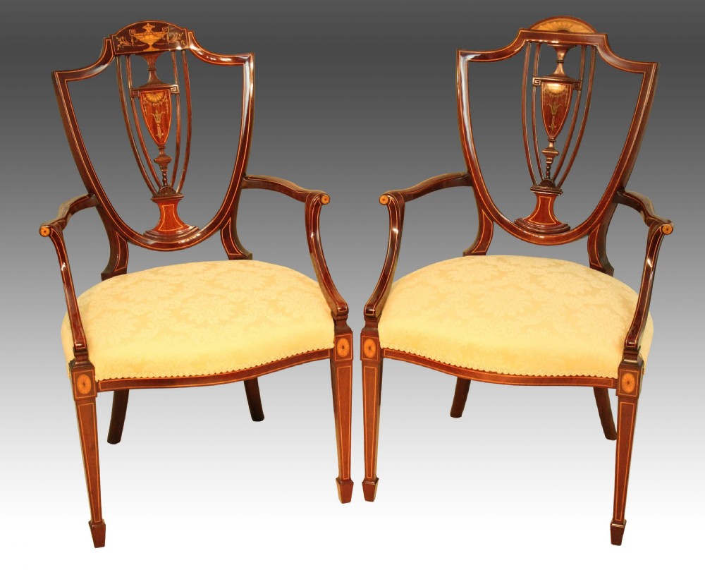 A fine pair of Late Victorian Mahogany inlaid shield back ladies and gents armchairs by Maple & Co