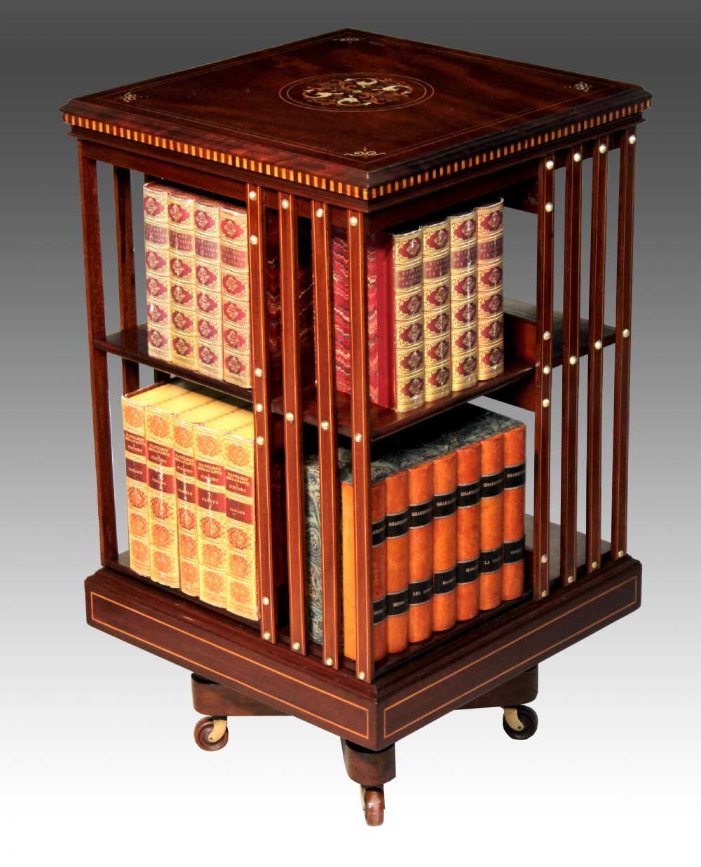An Exquisite Late Victorian Mahogany inlaid revolving bookcase by Maple & Co.