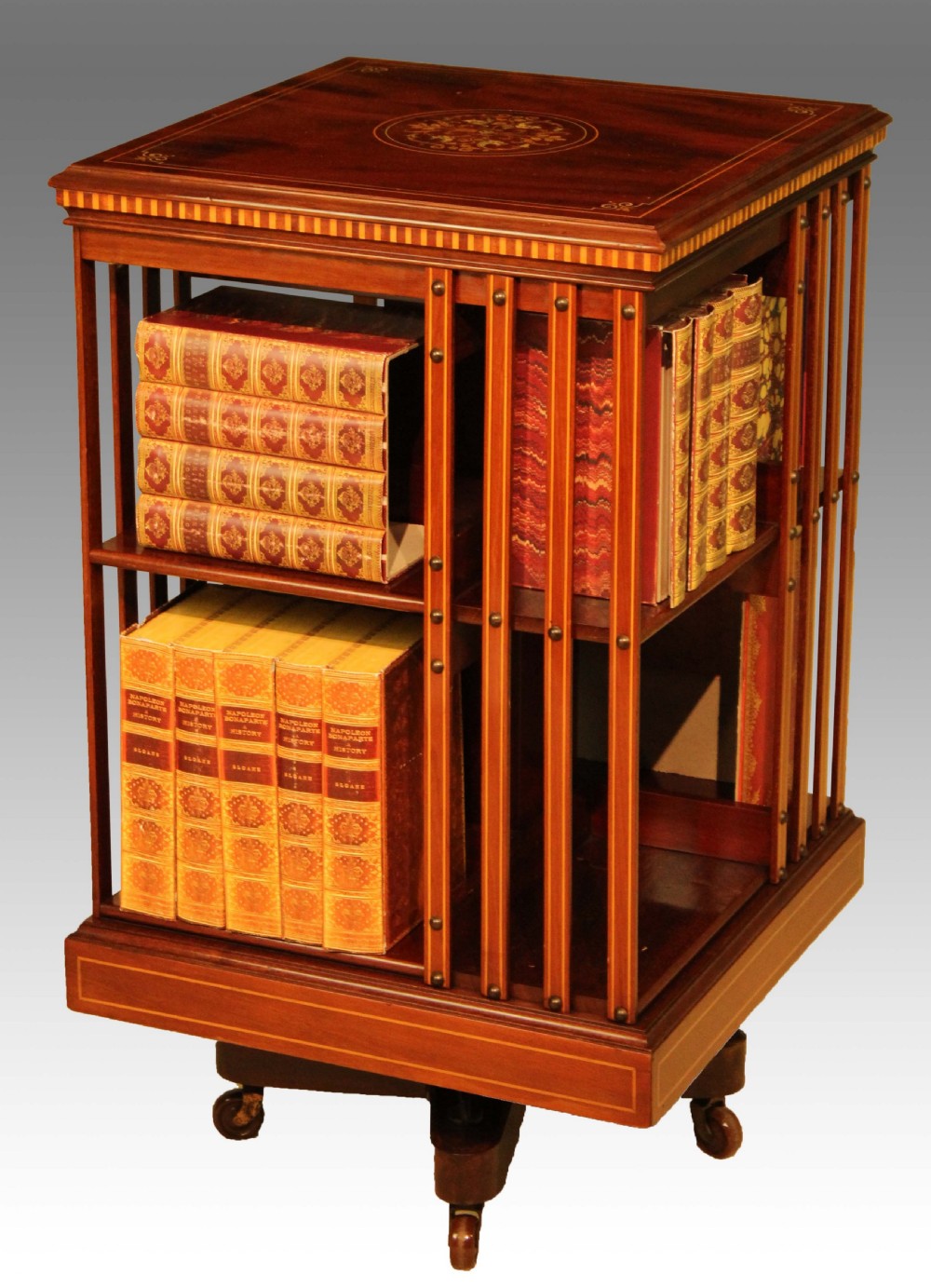 An Exquisite Late Victorian Mahogany inlaid revolving bookcase by Maple & Co.