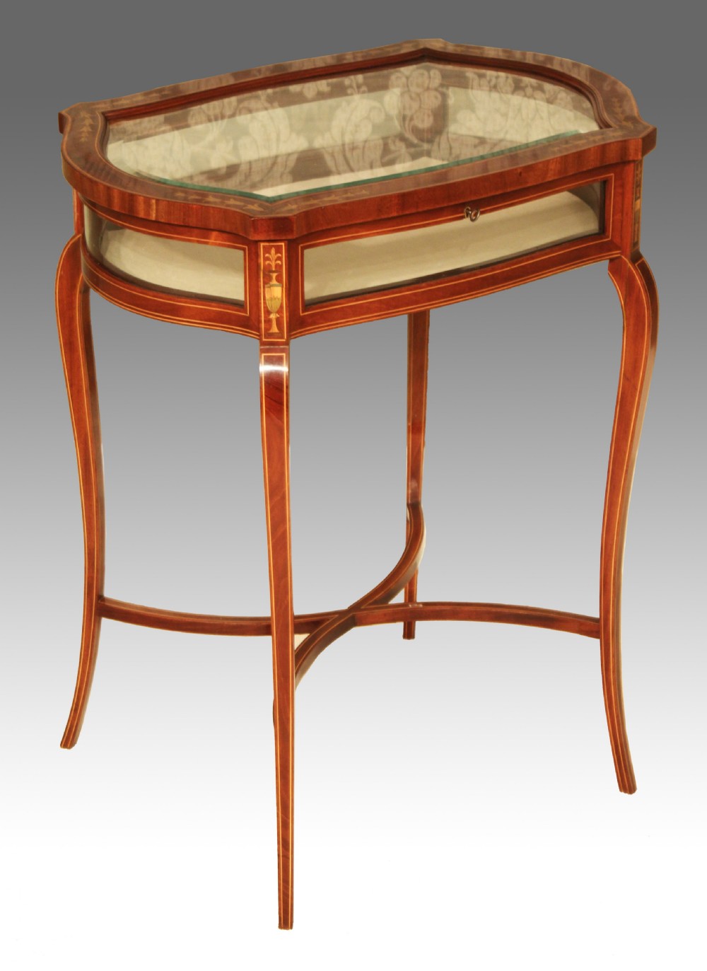 A Fine quality late Victorian mahogany inlaid serpentine shaped bijouterie table