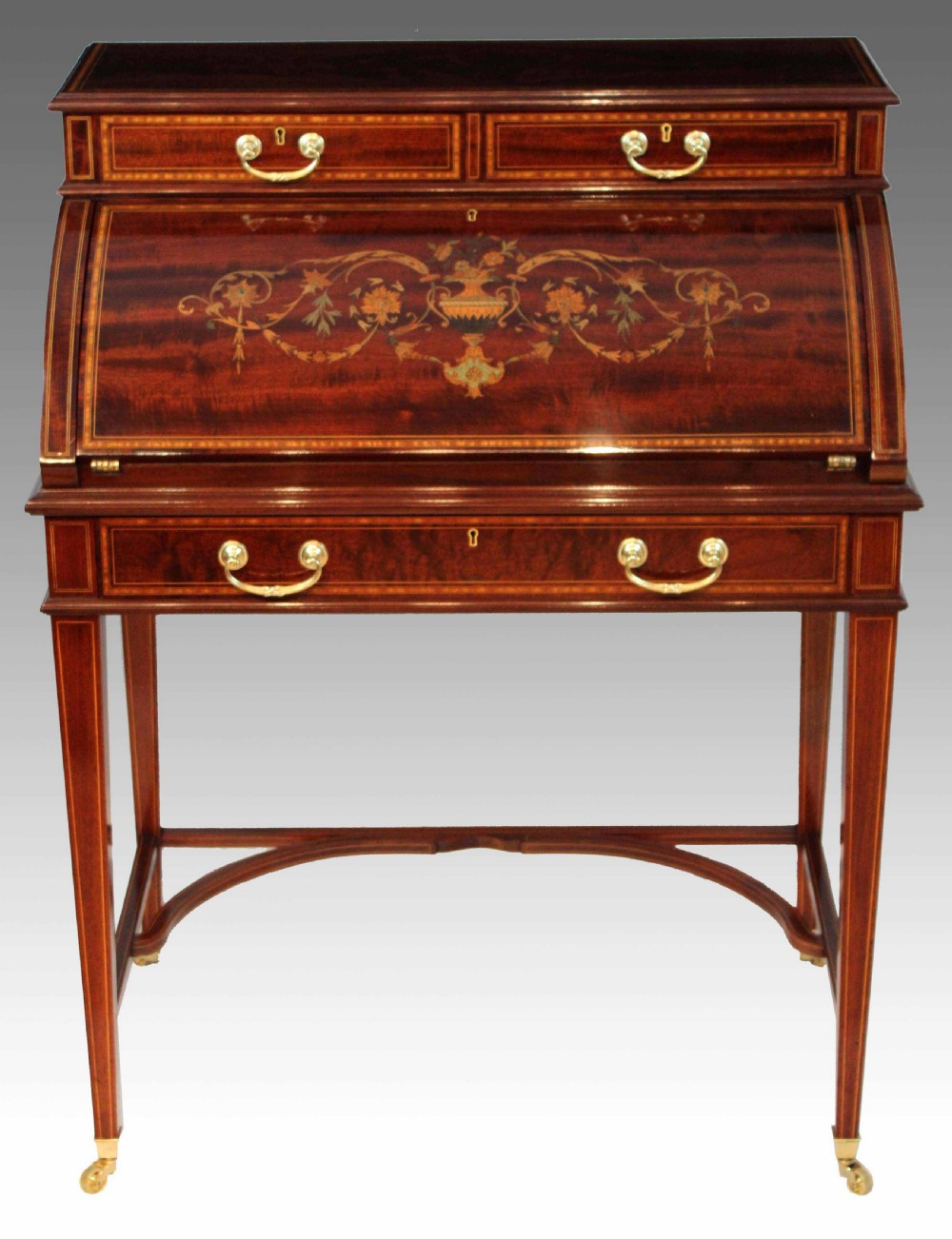 A Beautiful Late Victorian Mahogany cylinder desk by Maple & Co.