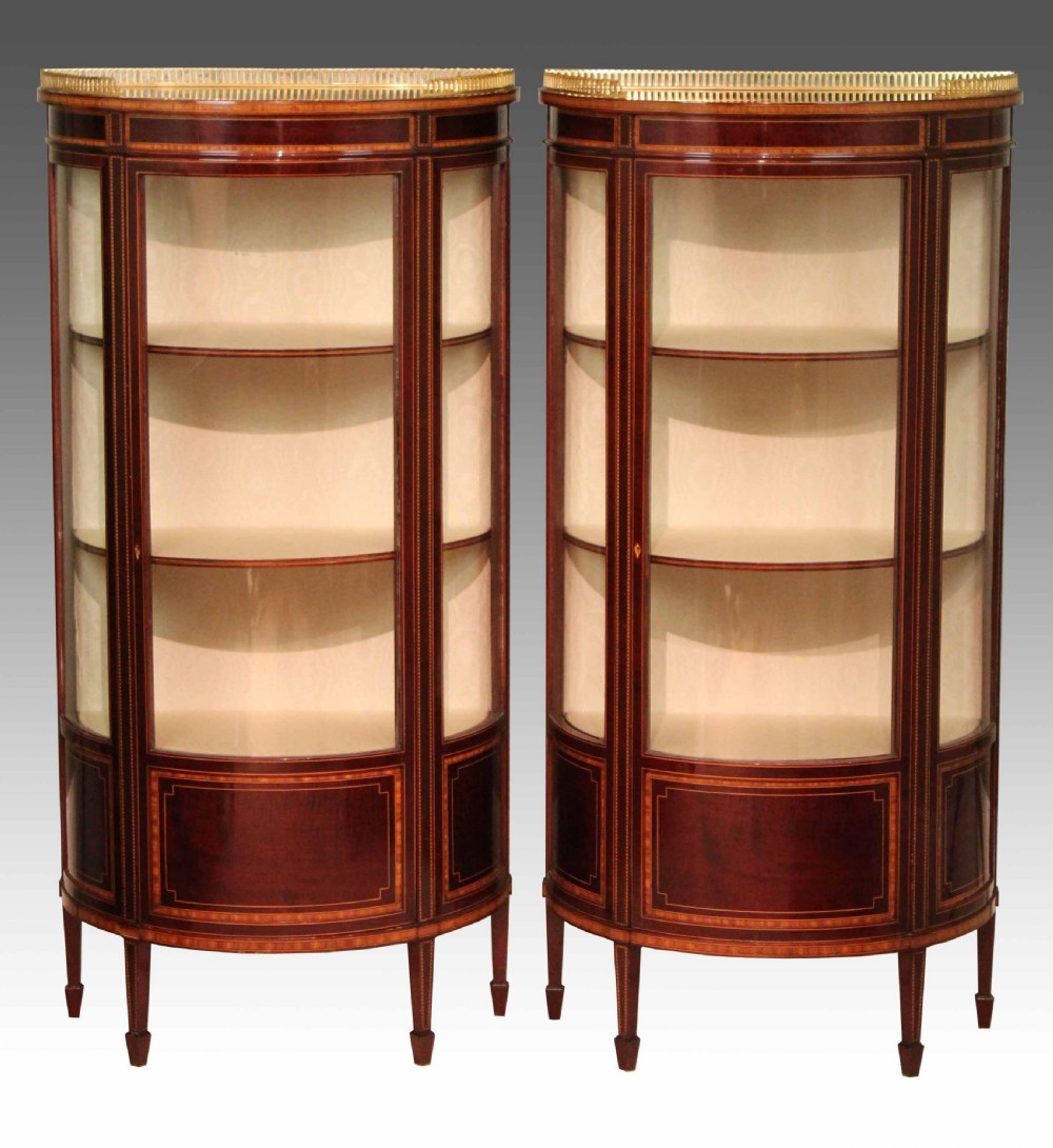 A Fine Quality Pair of Edwardian Inlaid Bow-front Glazed Display Cabinets