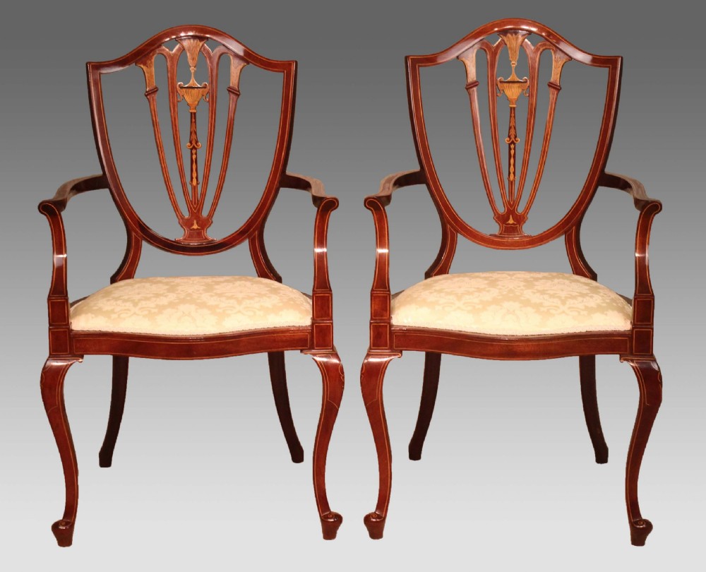 A Fine Pair of Late Victorian Mahogany inlaid shield back ladies and gents armchairs by Edwards & Roberts.