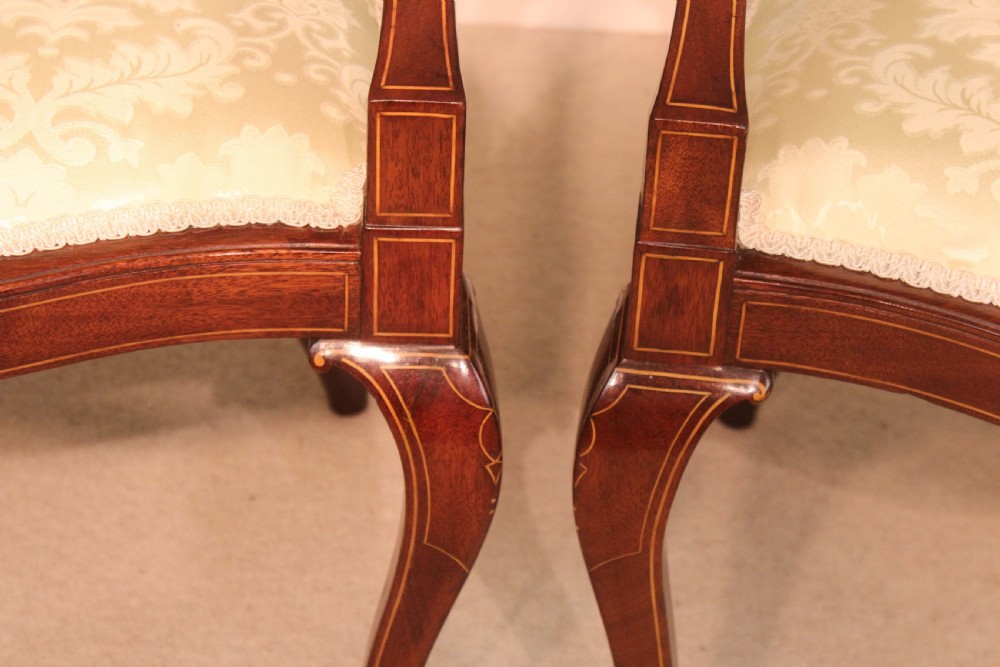 A Fine Pair of Late Victorian Mahogany inlaid shield back ladies and gents armchairs by Edwards & Roberts. View V