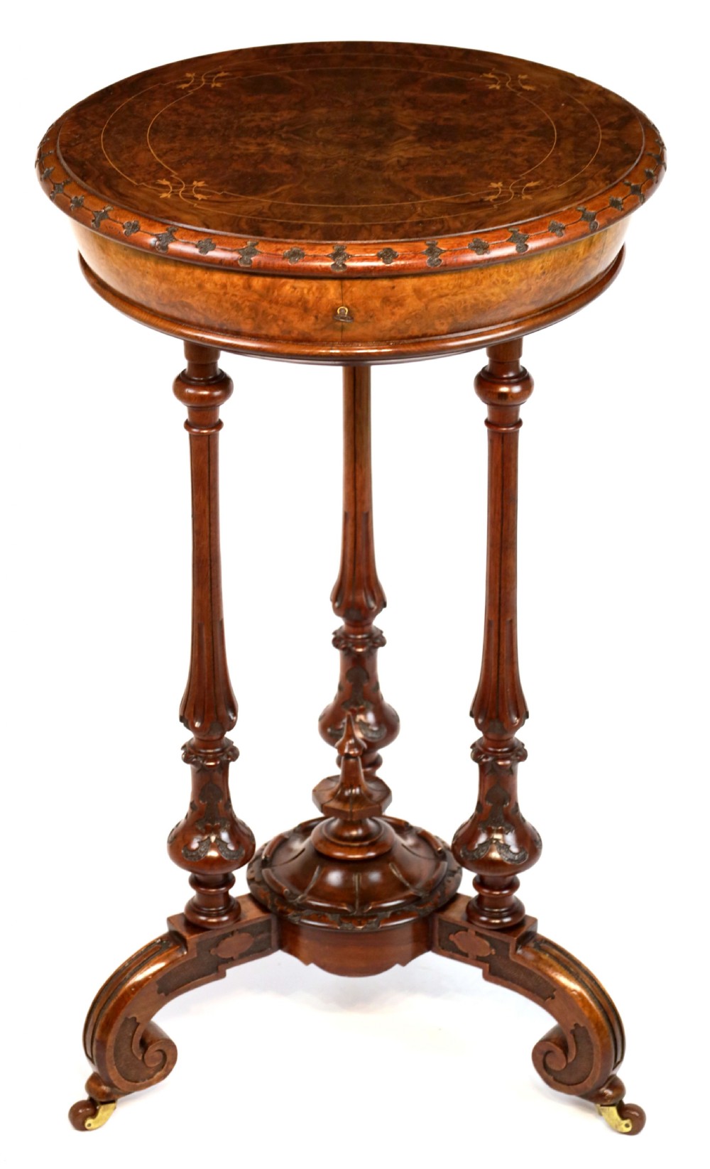 A Victorian Walnut Circular Work Table in the Manner of Gillows
