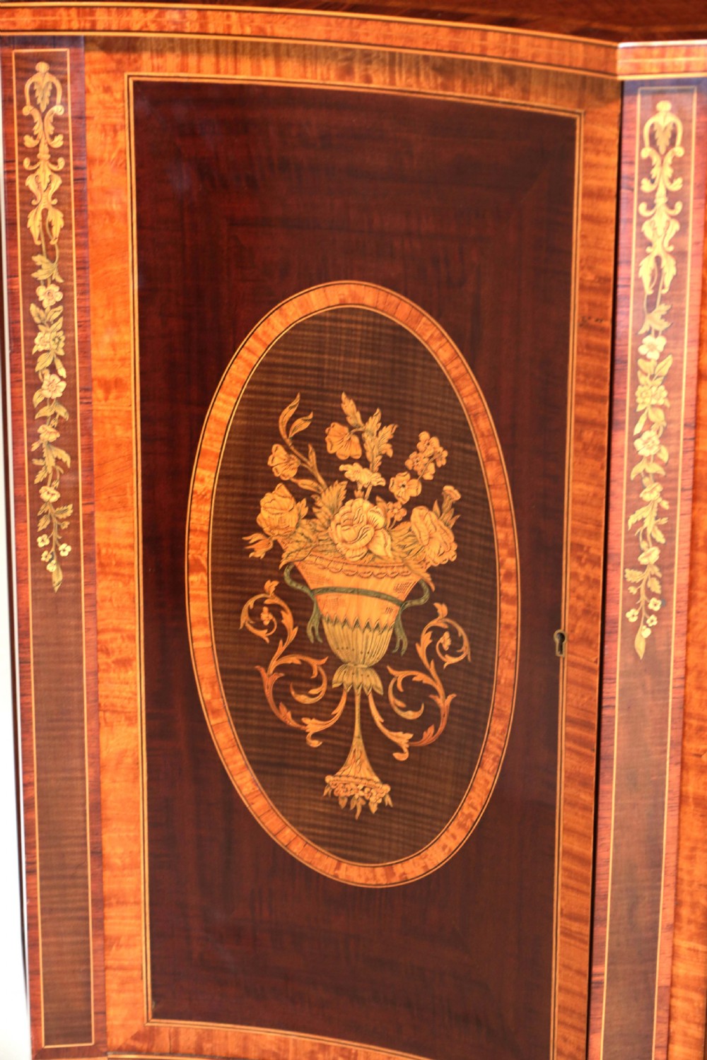 A Superb Late Victorian Mahogany Inlaid Serpentine Commode View II