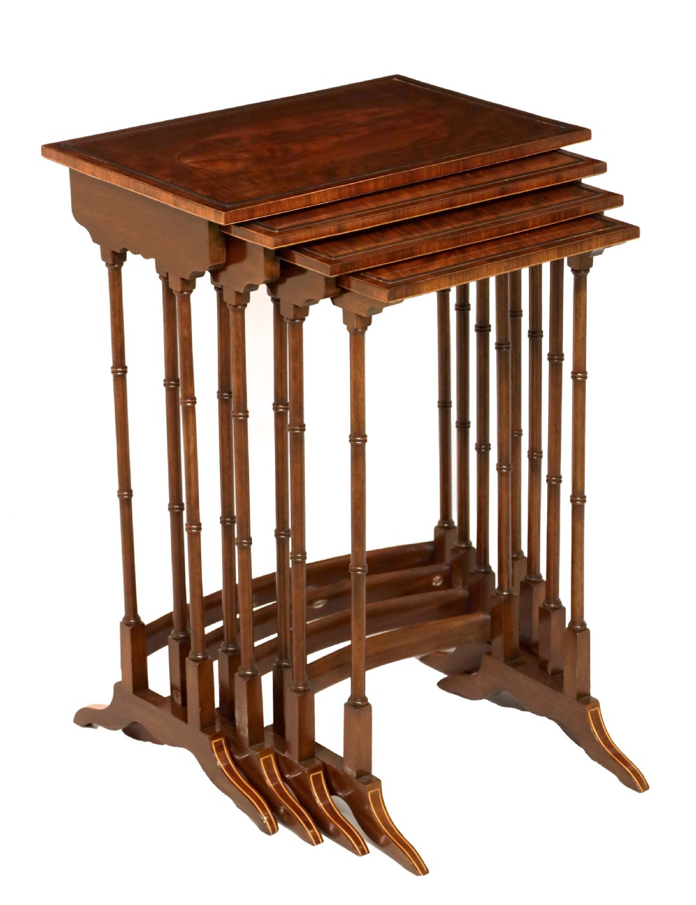 A set of four graduated nesting tables crafted from dark mahogany wood featuring line inlay and slender turned legs.