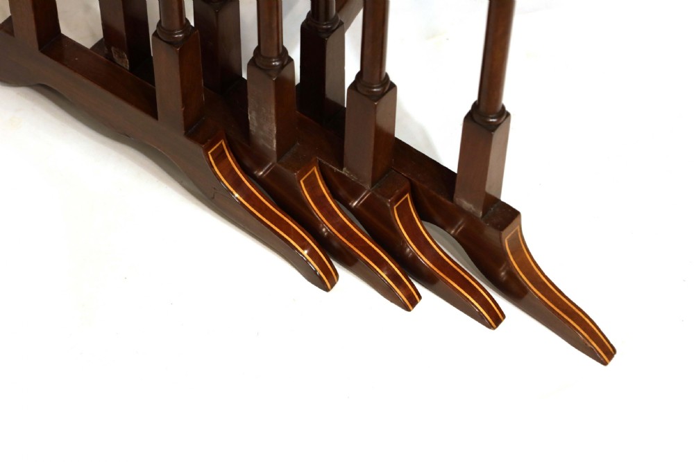 A set of four graduated nesting tables crafted from dark mahogany wood featuring line inlay and slender turned legs. View II