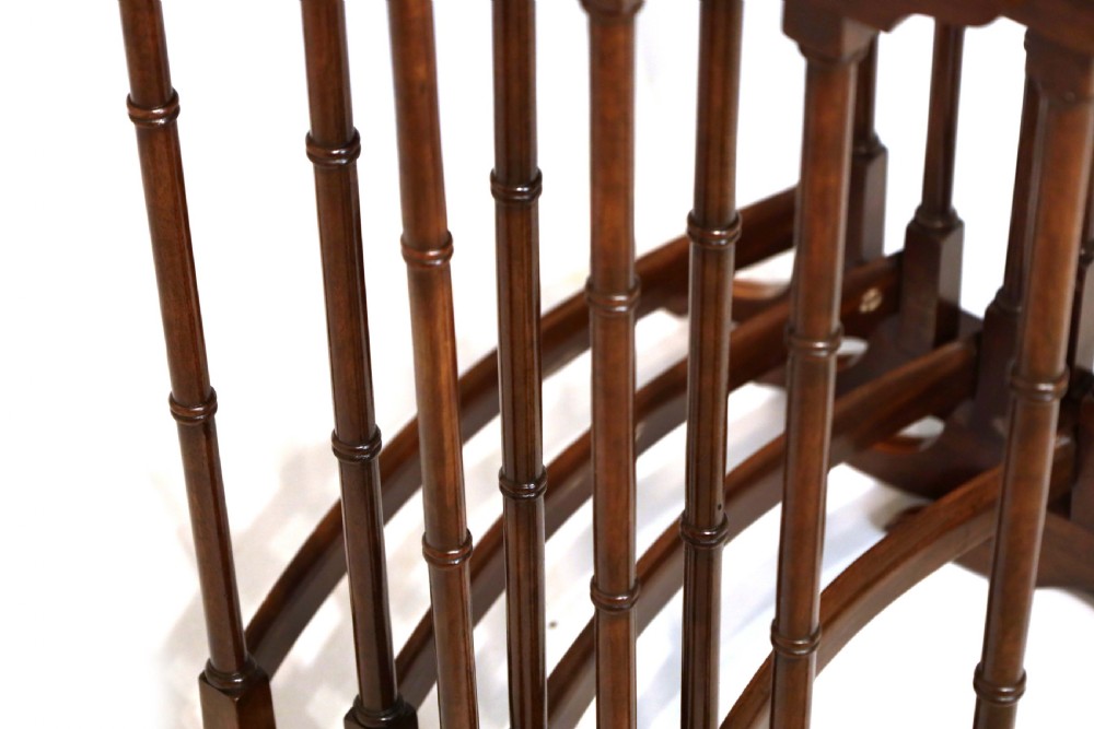 A set of four graduated nesting tables crafted from dark mahogany wood featuring line inlay and slender turned legs. View V