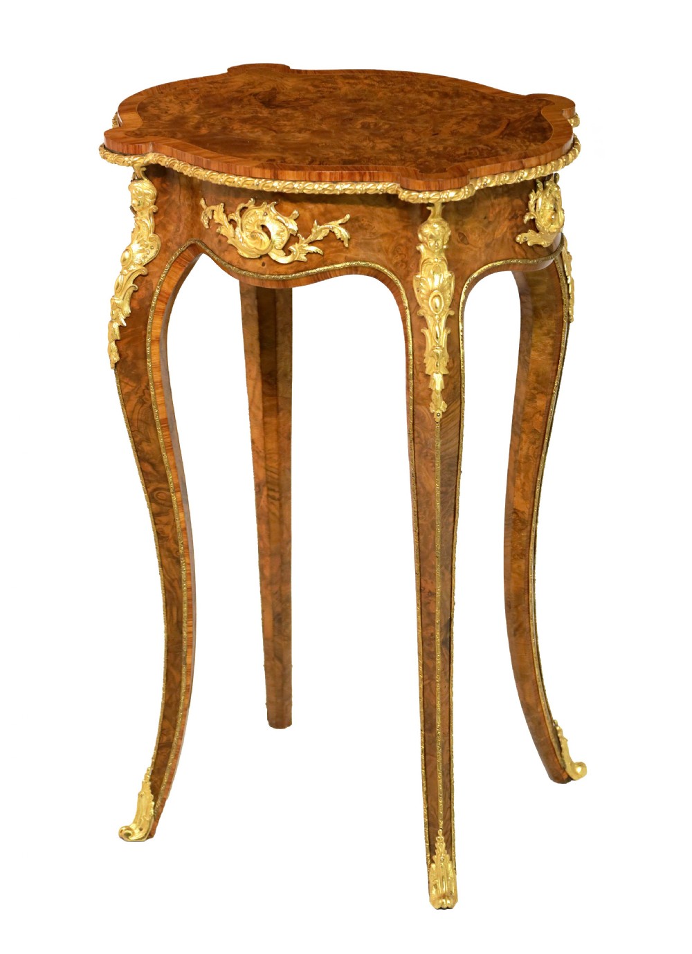 A Victorian burr walnut occasional table featuring a serpentine-edged top, cabriole legs, and ornate gilt bronze mounts along the apron and feet.