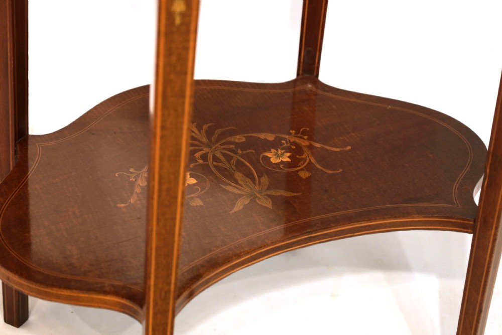 A late Victorian kidney-shaped mahogany side table featuring decorative floral marquetry inlay, slender tapered legs, a small apron drawer, and a lower tier shelf. View IV