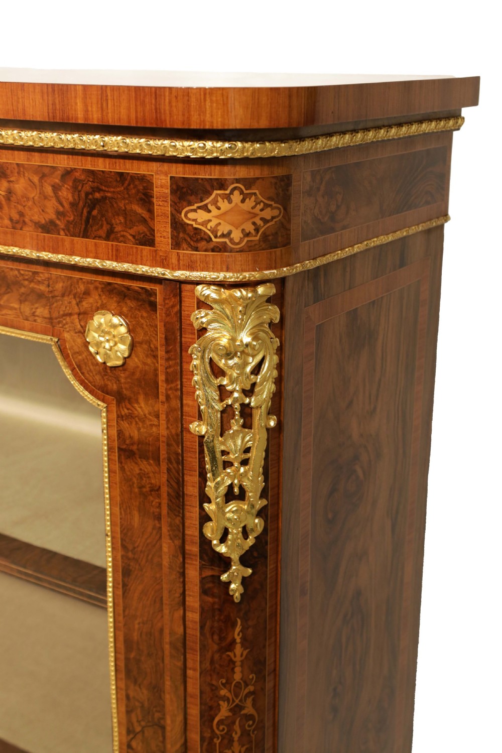 A pair of late nineteenth-century glazed display cabinets crafted from kingwood and walnut with decorative gilt-bronze mounts. View V