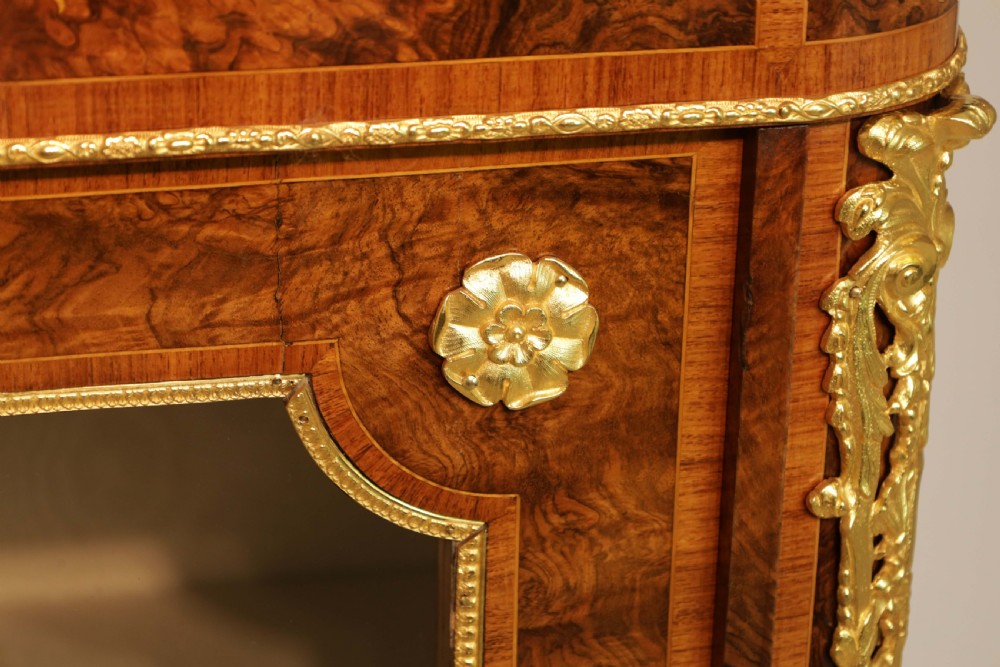 A pair of late nineteenth-century glazed display cabinets crafted from kingwood and walnut with decorative gilt-bronze mounts. View VI