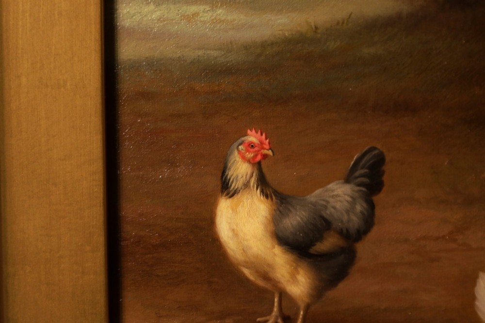 A framed oil painting depicting chickens, a cockerel, and ducks feeding outside a wooden barn, set within an ornate gilded frame. View III