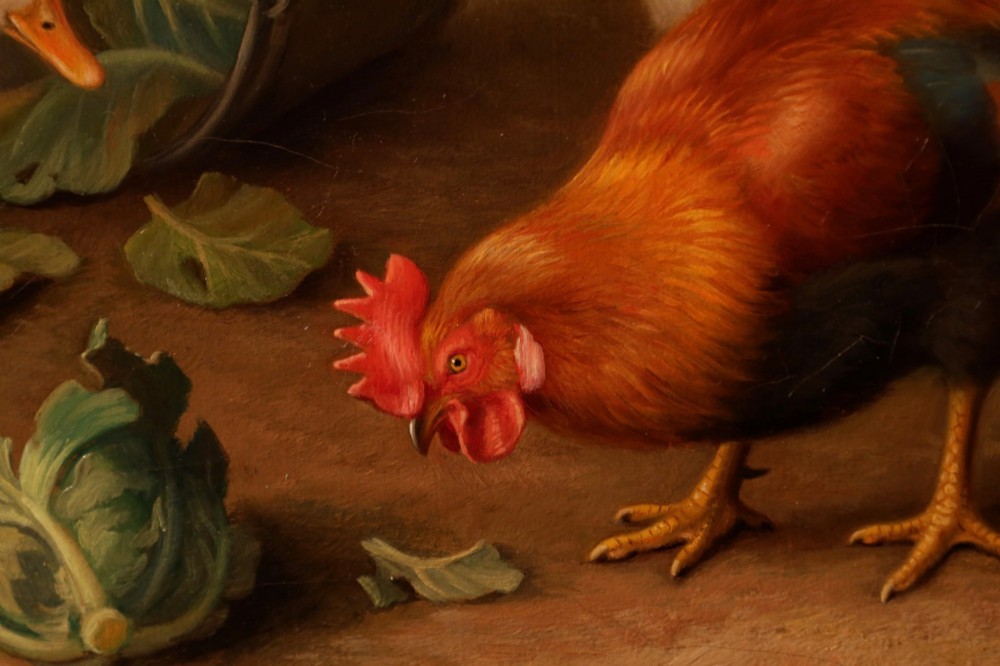 A framed oil painting depicting chickens, a cockerel, and ducks feeding outside a wooden barn, set within an ornate gilded frame. View V