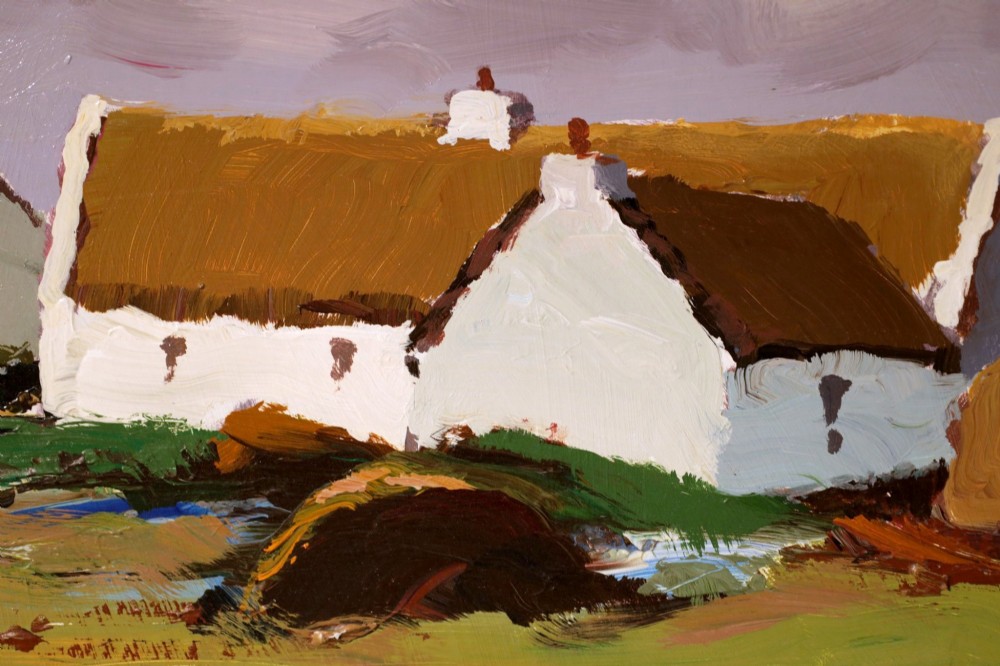An original oil painting on board by Donald McIntyre depicting whitewashed coastal cottages with thatched roofs set in a green landscape, framed in a silver moulding. View IV