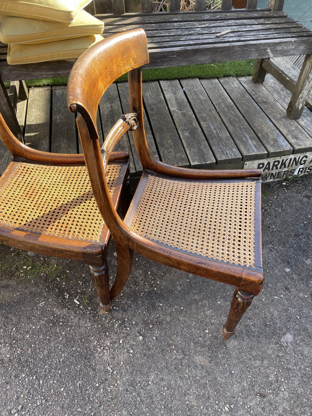 A set of four William IV mahogany dining chairs featuring carved back rails, turned front legs, and light green upholstered seat cushions. View II