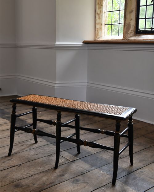 A MID 19TH CENTURY ENGLISH EBONISED AND POLYCHROME WINDOW SEAT