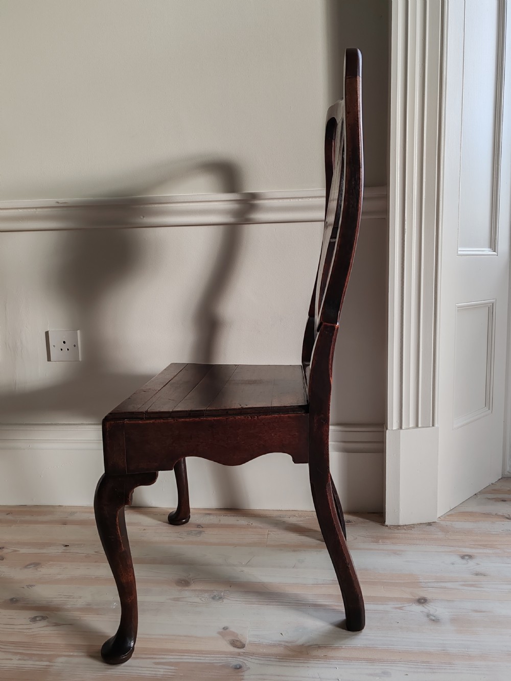 A mid-18th-century walnut side chair with a vase-shaped back splat, solid wooden seat, and front cabriole legs. View IV