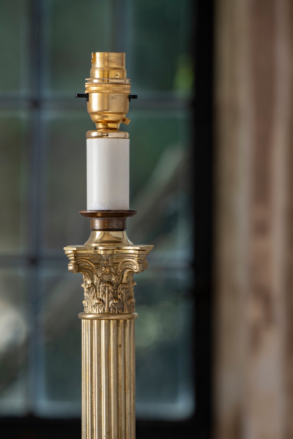 A nineteenth-century brass table lamp featuring a fluted column, classical capital, and square stepped base. View II
