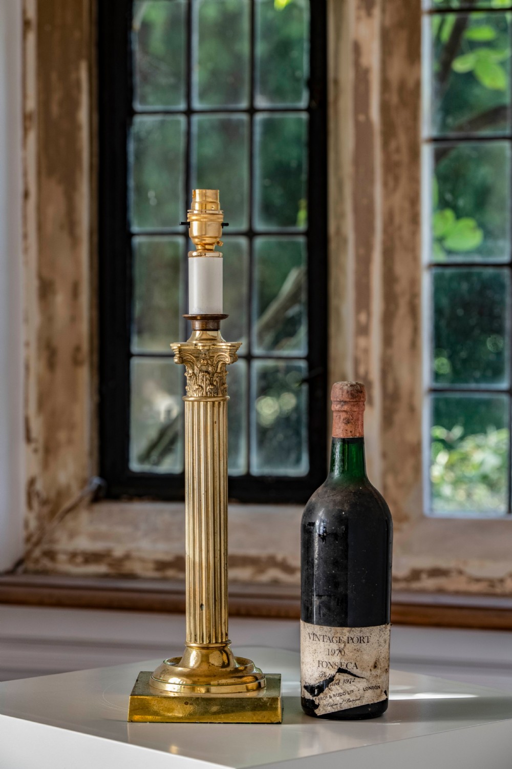 A nineteenth-century brass table lamp featuring a fluted column, classical capital, and square stepped base. View III