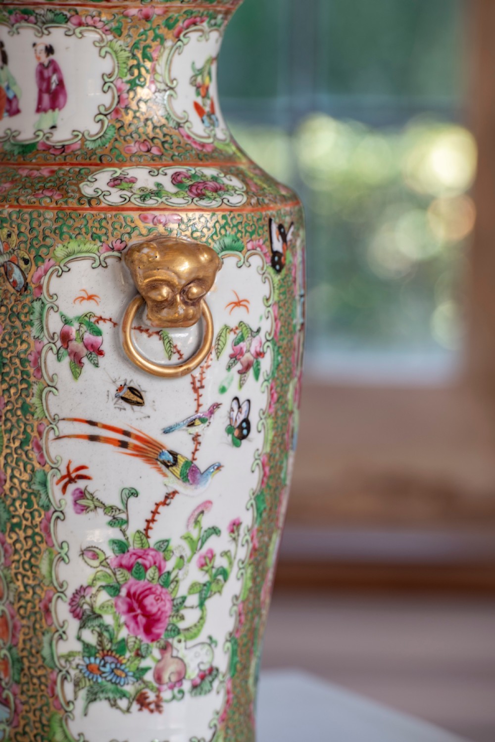 A pair of large Chinese Canton porcelain vase lamps with hand-painted polychrome figural panels, floral borders, and brass light fittings. View II